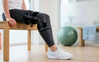 Patient comparing sports physical therapy clinics online while reviewing treatment options and rehabilitation services