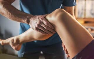 Sports physical therapist guiding an athlete through strength, mobility, and performance training exercises during rehabilitation