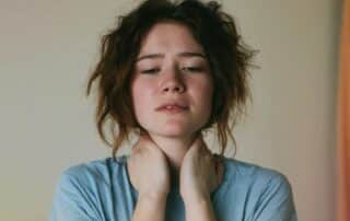 A thoughtful woman looking slightly fatigued, representing potential signs of a hidden hormonal imbalance.